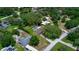 Aerial view of the home with pool and surrounding homes and tree coverage at 3567 Red Oak Ct, Lake Wales, FL 33898