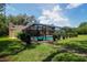 Aerial view of a pool with screened enclosure and well-manicured backyard, ideal for outdoor living at 3567 Red Oak Ct, Lake Wales, FL 33898