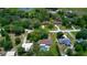 This stunning aerial view displays the home's location with mature trees surrounding the in-ground pool area at 3567 Red Oak Ct, Lake Wales, FL 33898