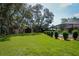 Beautiful, spacious backyard with luscious green grass, mature trees and outbuildings at 3567 Red Oak Ct, Lake Wales, FL 33898