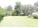 Expansive backyard with mature trees, green lawn, and lush landscaping for outdoor enjoyment and privacy at 3567 Red Oak Ct, Lake Wales, FL 33898