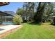 Large backyard featuring mature trees, pool and various outbuildings at 3567 Red Oak Ct, Lake Wales, FL 33898