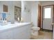 Bathroom with a single sink vanity and a door leading to outside at 3567 Red Oak Ct, Lake Wales, FL 33898