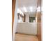Bathroom vanity with neutral colors, a large mirror, and neutral countertops and cabinets at 3567 Red Oak Ct, Lake Wales, FL 33898