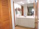 Well-lit bathroom featuring a vanity with cabinets, mirror, and a glimpse of the bedroom at 3567 Red Oak Ct, Lake Wales, FL 33898