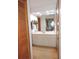 Well-lit bathroom featuring a vanity with cabinets, mirror, and a glimpse of the bedroom at 3567 Red Oak Ct, Lake Wales, FL 33898