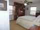 Cozy bedroom featuring a built-in bookcase, ceiling fan, and light blue textured walls at 3567 Red Oak Ct, Lake Wales, FL 33898