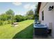 Exterior view of the home with a view of the HVAC, well maintained lawn, and dog house at 3567 Red Oak Ct, Lake Wales, FL 33898
