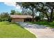 Charming single-story home with a two-car garage and mature landscaping at 3567 Red Oak Ct, Lake Wales, FL 33898