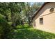 Exterior view of the home with an expansive green lawn and mature trees at 3567 Red Oak Ct, Lake Wales, FL 33898