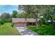 Charming single-story home with a two-car garage and mature landscaping at 3567 Red Oak Ct, Lake Wales, FL 33898