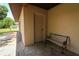 Covered entry to home with bench seating and neutral color palette at 3567 Red Oak Ct, Lake Wales, FL 33898