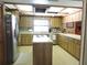 Spacious kitchen with stainless steel appliances, light countertops and light wood cabinetry at 3567 Red Oak Ct, Lake Wales, FL 33898