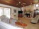 Inviting living room featuring a stone fireplace, wood ceiling, and comfortable seating area at 3567 Red Oak Ct, Lake Wales, FL 33898