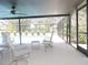 Inviting screened patio features comfortable seating and provides a relaxing outdoor space by the pool at 3567 Red Oak Ct, Lake Wales, FL 33898