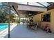 Spacious covered patio with ample seating for outdoor dining and relaxation by the inviting pool at 3567 Red Oak Ct, Lake Wales, FL 33898