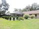 Backyard featuring a screened-in pool with manicured lawn and lush landscaping for a private outdoor oasis at 3567 Red Oak Ct, Lake Wales, FL 33898