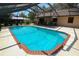 Sparkling pool surrounded by a screened enclosure and a spacious deck for outdoor enjoyment at 3567 Red Oak Ct, Lake Wales, FL 33898