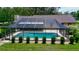 A screened-in pool area with a pristine pool is surrounded by a neat row of small bushes at 3567 Red Oak Ct, Lake Wales, FL 33898