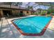 Sparkling pool surrounded by a screened enclosure and a spacious deck for outdoor enjoyment at 3567 Red Oak Ct, Lake Wales, FL 33898