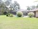 Backyard with a screened-in pool, lush greenery, and patio furniture for relaxing outdoor living at 3567 Red Oak Ct, Lake Wales, FL 33898
