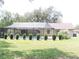 Backyard oasis featuring a screened-in pool, neat hedges, and a well-maintained lawn for outdoor enjoyment at 3567 Red Oak Ct, Lake Wales, FL 33898