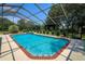 Backyard features a sparkling pool with a screened enclosure offering privacy and outdoor enjoyment at 3567 Red Oak Ct, Lake Wales, FL 33898