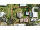 Aerial view of a property with a fenced backyard, a detached garage, and mature landscaping within a defined property line at 450 Westfall Dr, Kenansville, FL 34739