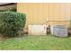 Home exterior featuring a backup generator and AC unit, set amongst a green lawn at 450 Westfall Dr, Kenansville, FL 34739