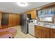 View of the kitchen featuring wood cabinets, a stainless steel refrigerator, and a double-basin sink at 450 Westfall Dr, Kenansville, FL 34739