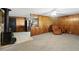 Cozy living room with wood paneled walls, tile flooring, and a wood-burning stove at 450 Westfall Dr, Kenansville, FL 34739