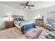 Bedroom with a cozy rug, a ceiling fan, and a large bed with wood trim and bedside tables at 4833 Drake Ave, Lakeland, FL 33811