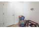 Hallway with a white door, tiled flooring, and a security system panel at 4833 Drake Ave, Lakeland, FL 33811