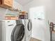 This laundry room offers a white washer and dryer and shelving at 4833 Drake Ave, Lakeland, FL 33811