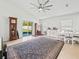 Bright living room with tile floors, modern ceiling fan, and sliding door access to the backyard at 4833 Drake Ave, Lakeland, FL 33811