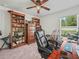 This office boasts a ceiling fan, large wood shelving, a window and guitars at 4833 Drake Ave, Lakeland, FL 33811