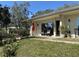 Landscaped front yard with flowers leading to the entrance of the home with a shaded seating area at 711 Springer Dr # 9, Lake Wales, FL 33853