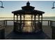 Tranquil gazebo on a pier provides the perfect spot to relax and watch a serene sunset at 711 Springer Dr # 9, Lake Wales, FL 33853