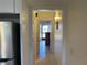 Hallway with tile flooring that connects to the kitchen and to the living area at 711 Springer Dr # 9, Lake Wales, FL 33853