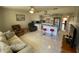 Inviting living room featuring tile floors, ceiling fan, and an open layout to the modern kitchen at 711 Springer Dr # 9, Lake Wales, FL 33853