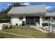 Poolside view of a screened-in pool house with ample seating and well-maintained landscaping at 711 Springer Dr # 9, Lake Wales, FL 33853