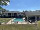 Fenced in pool between two buildings with outdoor seating and a well-maintained lawn at 711 Springer Dr # 9, Lake Wales, FL 33853