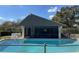 Sparkling pool with adjacent pool house featuring a screened-in area and comfortable seating at 711 Springer Dr # 9, Lake Wales, FL 33853