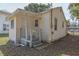 This image shows the back porch of this home, which has wood railings and access steps at 720 S Orange Ave, Bartow, FL 33830