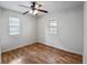 Cozy bedroom featuring wood floors, bright natural light, and neutral walls at 720 S Orange Ave, Bartow, FL 33830