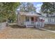 Quaint single-story home featuring a cozy front porch and small, fenced yard at 720 S Orange Ave, Bartow, FL 33830