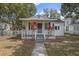 Charming bungalow-style home with a covered front porch and mature landscaping at 720 S Orange Ave, Bartow, FL 33830