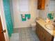 Bathroom featuring a vanity with sink, toilet, and shower with teal curtain at 9 Silver Sand Rd, Frostproof, FL 33843