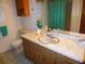 Traditional bathroom featuring a marble countertop, wood cabinets, and a toilet at 9 Silver Sand Rd, Frostproof, FL 33843