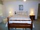 Bedroom with bed, side tables, lamps, chair, and natural light at 9 Silver Sand Rd, Frostproof, FL 33843